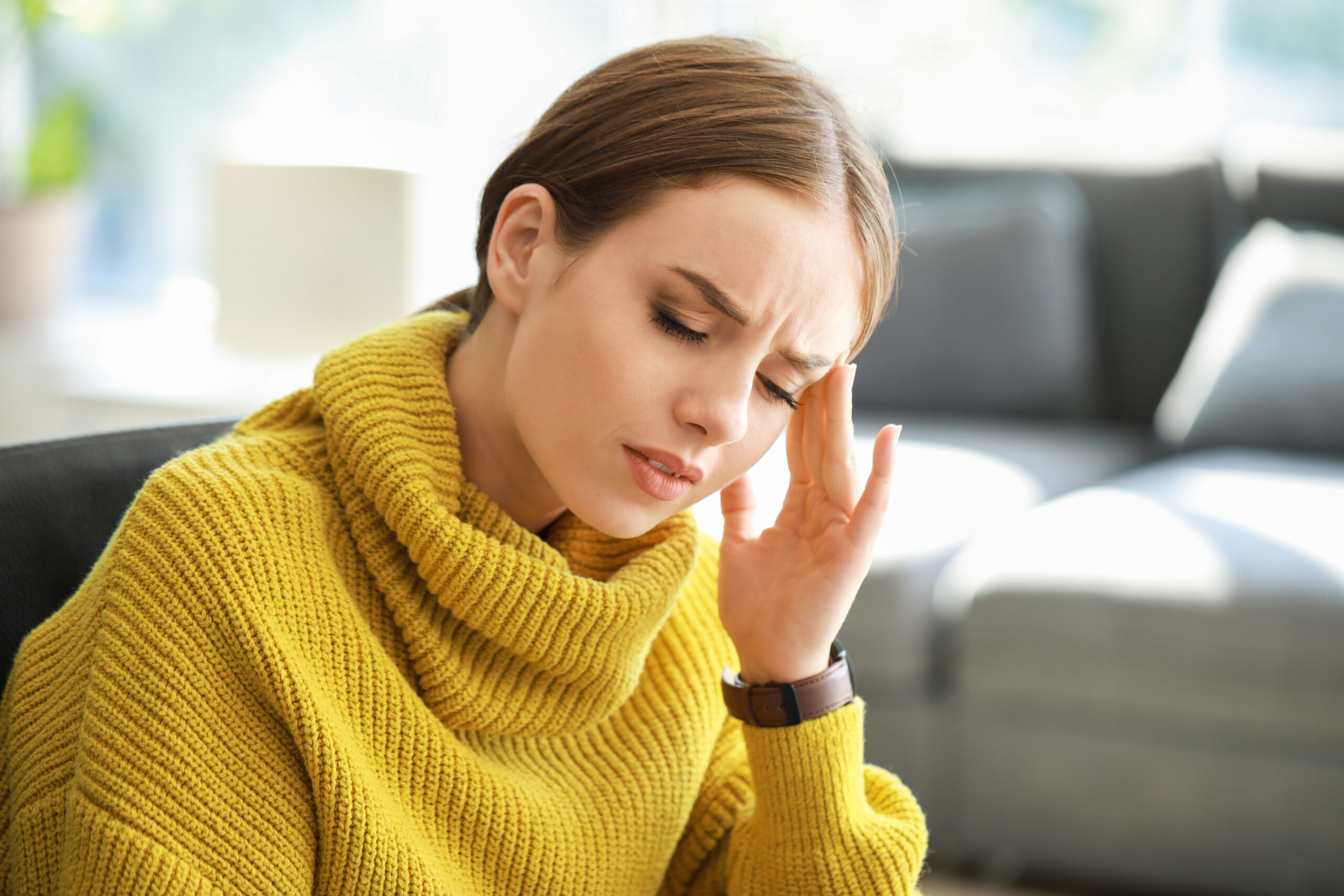 Young woman suffering from headache at home tarzana, ca